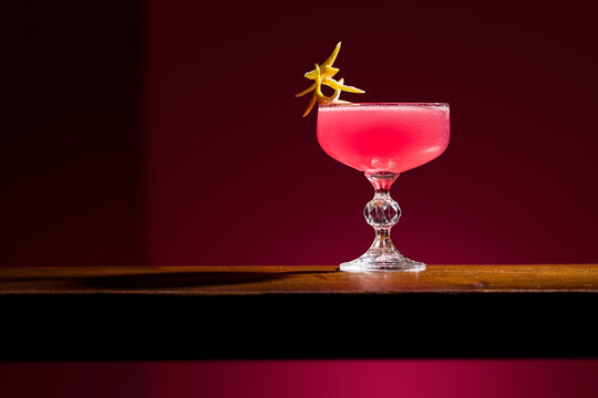 Elegant Cosmopolitan Cocktail on Wooden Surface with Garnish