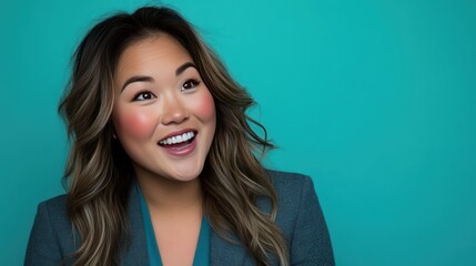 Smiling Woman in Blue Blazer Against Teal Background