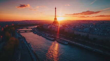 A breathtaking aerial view of Paris at sunset, with the Eiffel Tower glowing brightly