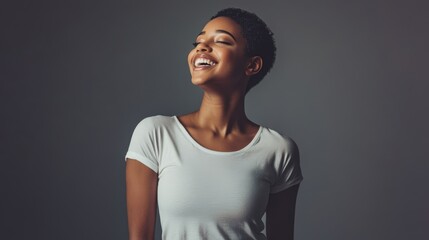Obraz premium A fit young woman in a white t-shirt, standing tall with a big smile,
