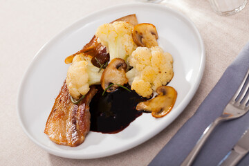 Appetizing cauliflower with bacon and mushrooms