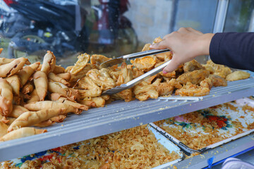 Obraz premium A typical Indonesian snack consisting of bananas, cassava and fried tofu. In Indonesia it is called gorengan