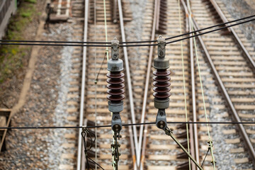 isolator on a power line for electric passenger trains in front of railway tracks