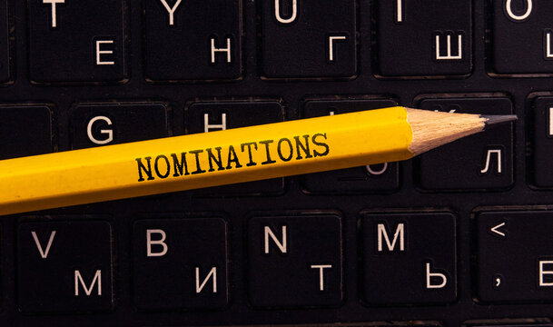 Magnifying glass and brown card with text NOMINATIONS