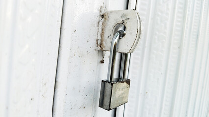 Iron door with padlock. Security efforts for houses and shops in urban areas. Symbolizing Security Measures In Urban Environments
