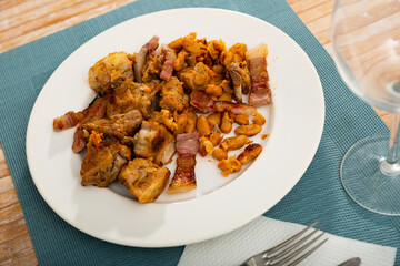 Delicious fried pork with beans in gravy on a plate