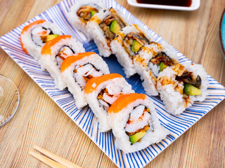 Traditional Japanese Uramaki sushi roll with grilled eel and fresh salmon.