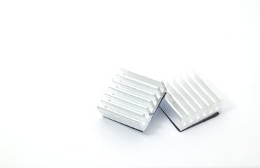 Front view of 2 aluminum heat sinks on a white background. Component part of electronic or computer work.