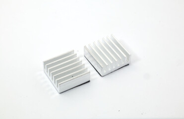 Front view of 2 aluminum heat sinks on a white background. Component part of electronic or computer work.