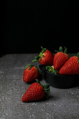 Fresh Strawberries on dark background. Summer red fruit with Copy space for text. Organic healthy eating.