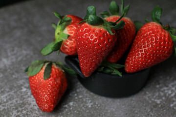 Fresh Strawberries on dark background. Summer red fruit with Copy space for text. Organic healthy eating.