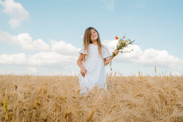 Happy smiling kid enjoying vacation in park.Wheat field sunny day.Little girl running through field of wheat, sunset.