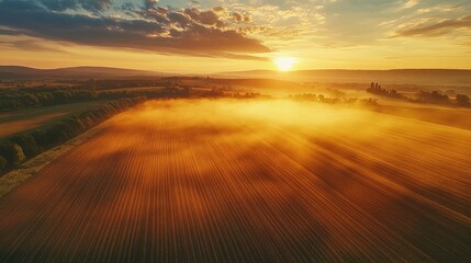 Obraz premium Tranquil agricultural landscape with a magical rainbow at sunset