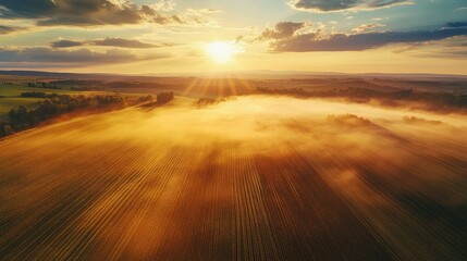 Tranquil agricultural landscape with a magical rainbow at sunset