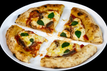 Anchovy pizza isolated on black background top view