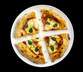 Anchovy pizza isolated on black background top view