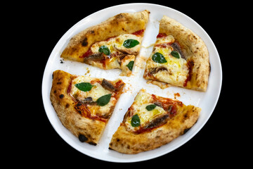 Anchovy pizza isolated on black background top view