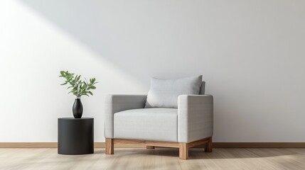 A realistic photo of a serene living space featuring a light gray armchair and a matching wooden side table. The black vase with greenery adds a subtle, natural element to the simple design, styled