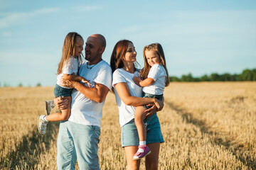  Happy family and little baby.Wheat field sunny day.Little girl running through field of wheat, sunset.