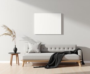 Minimalist living room interior with a neutral color scheme. Features a light gray sofa with a dark throw blanket, flanked by two wooden side tables holding vases with dried branches and greenery.