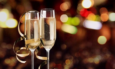 Two glasses of tasty champagne on festive christmas background.