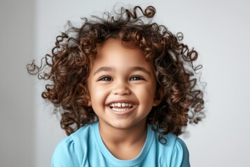professional portrait of happy mixed race girl child model with curly hair laughing and smiling isolated on white background for ads and web design