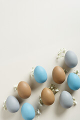 Elegant Easter Composition with Pastel Eggs and Spring Blossoms, still life Dyed eggs in soft pastel colors, top view spring holiday minimal creative pattern, neutral earth colored image, above