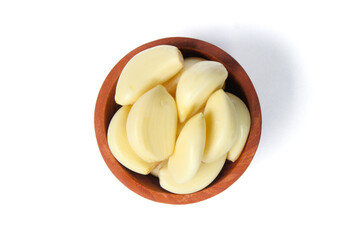 Garlic in a small wooden bowl isolated on white background. Food ingredients. Top view