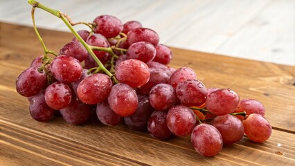 Delicious red globe grapes on wooden table for global export, grapes, red, delicious, cluster, wooden table, sweetness, juicy