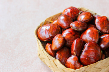 Dogfruit (Archidendron pauciflorum) an Indonesia commonly called djenkol, jengkol or jering on wooden woven container. Food Ingredients