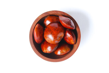 Dogfruit (Archidendron pauciflorum) an Indonesia commonly called djenkol, jengkol or jering on a small wooden bowl isolated on white background. Food Ingredients