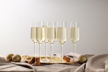 A bottle of champagne with glasses on a light background