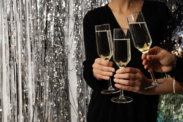 Glasses of champagne in female hands at a party