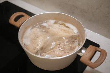 Boiling Chicken in a Pot for Cooking Delicious Homemade Meals with Nutritious Ingredients