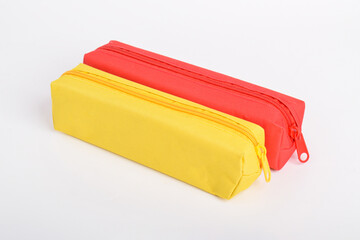 Bright yellow and red school pencil case isolated on white background. School stationery. Back to school. Copy space