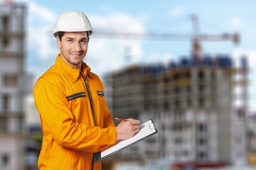 Construction workers in protective equipment working at the construction site.