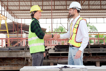 Engineers are working together at construction site.