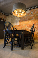 table and chairs with brick wall