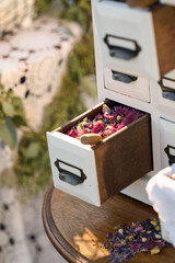 dried pink flower petals in white drawer