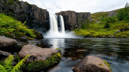 Fototapeta premium A stunning waterfall cascades into a serene pool, surrounded by lush greenery and rocky formations, creating a tranquil natural escape.