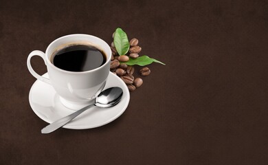 cup of hot coffee and aroma coffee beans on desk
