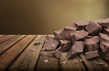 Broken dark sweet chocolate bar on desk