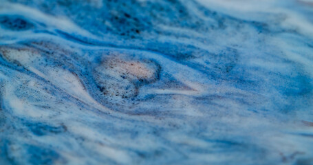 Marble flow. Wavy enamel. Disturbance of opaque paint. Pouring colored ink with gold glitter stone...
