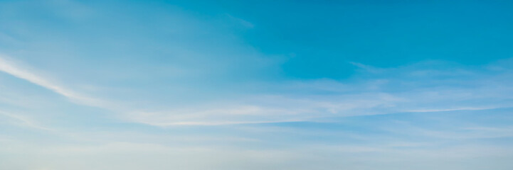 Clear blue sky with soft wispy clouds