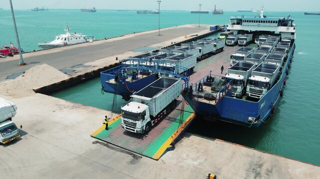 The truck was loading into a car carrier ship. Car ferry leaving docks fully loaded.