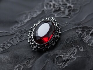 Fototapeta premium Explore the elegance of a stunning black lace brooch featuring a captivating red gemstone