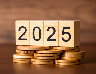 2025 on wooden block, stack of coins. time concept and money saving