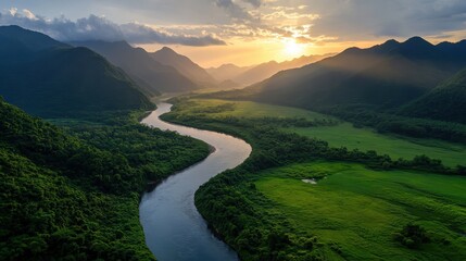 Explore the majestic beauty of nature as the river winds through lush green valleys beneath a stunning sunset
