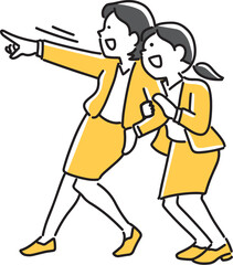 目標物を指さして見る2人の女性