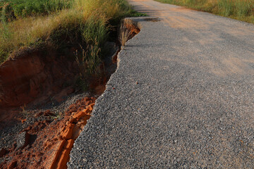 Landslide caused by rains occurs broken road asphalt. Broken asphalt road collapsed and fallen. Road collapses. Cracked asphalt road. Construction site.